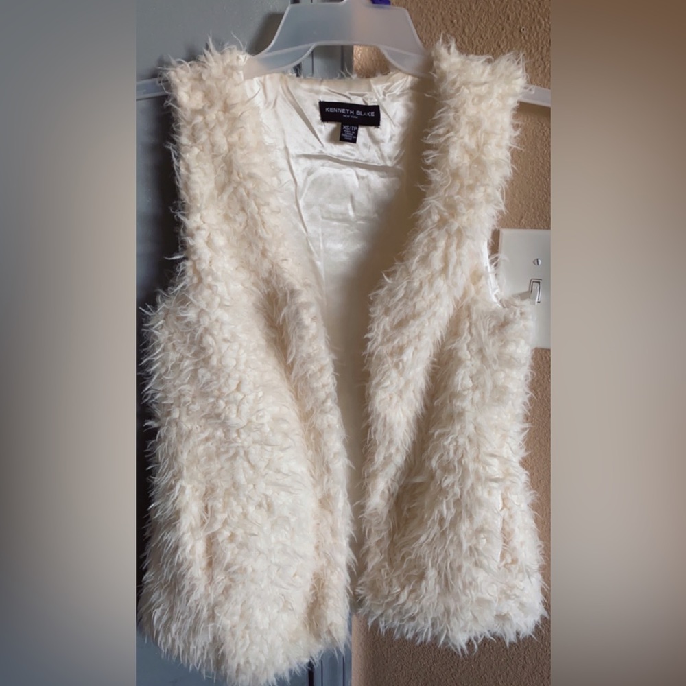 Kenneth Blake white furry vest